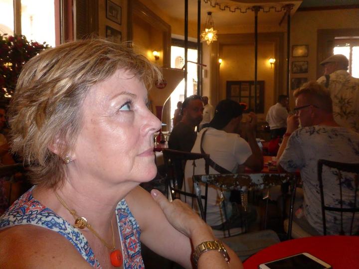 Sitting at a table in Floridita Bar Restaurant, waiting for a seat at the bar to come open.
